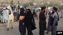 FILE - People walk through a street in Fayzabad of Badakhshan province, Sept. 15, 2022. A car bomb set off in the city, reportedly by IS-Khorasan, killed a provincial police chief and his two guards, according to Taliban authorities. 