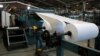 FILE - A worker prepares a roll of paper prior to running the presses in the La Prensa newspaper printing plant in Managua, Nicaragua Feb. 7, 2020. In 2022, La Prensa was forced to move its entire operation outside of the country.