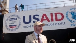 FILE - U.S. Ambassador to Sudan John Godfrey delivers a speech in the Sudanese Red Sea city of Port Sudan during the delivery of tons of corn as part of the U.S' support for Sudan in the field of humanitarian aid, on November 20, 2022.