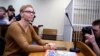 FILE - Marina Zolatava, editor-in-chief of the Belarusian independent news site Tut.by, sits in a courtroom prior to a court session in Minsk, Belarus, Feb. 12, 2019.