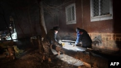 This undated handout photograph released on Dec. 9, 2022 by Kazakhstan's government press service shows workers repairing pipes of the heating system in Ekibastuz.