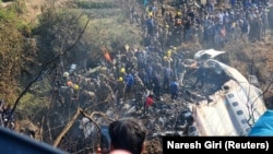 People gather after the plane crash in Pokhara, Nepal, Jan. 15, 2023 in this picture obtained from social media. (Naresh Giri/via Reuters)