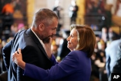 Speaker of the House Nancy Pelosi of Calif., embraces former Washington Metropolitan Police Department officer Michael Fanone before the start of a Congressional Gold Medal ceremony honoring law enforcement officers who defended the U.S. Capitol on Jan. 6, 2021, in the U.S. Capitol Rotunda in Washington, Tuesday, Dec. 6, 2022.
