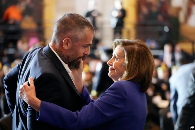 Speaker of the House Nancy Pelosi of Calif., embraces former Washington Metropolitan Police Department officer Michael Fanone before the start of a Congressional Gold Medal ceremony honoring law enforcement officers who defended the U.S. Capitol on Jan. 6, 2021, in the U.S. Capitol Rotunda in Washington, Tuesday, Dec. 6, 2022.