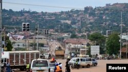 FILE - Motorists and cyclists are seen at a traffic light intersection in this general scene of Kampala, Uganda, Nov. 16, 2022.