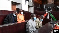 FILE: Four defendants linked with the Grand Bassam attack Kounta Sidi Mohamed (CL), Cisse Hantao Ag Mohamed (CR), Cisse Mohamed (R) and Barry Hassan (L) sit in the box of the accused during their trial at the criminal court of Abidjan on December 22, 2022