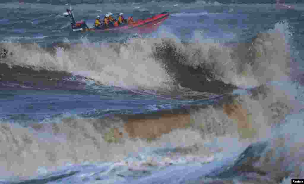 An RNLI inshore lifeboat battles through waves on the River Mersey near New Brighton, Britain.