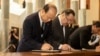 FILE - China's ambassador to Australia Xiao Qian writes a note while attending the national memorial service of Britain's Queen Elizabeth II in the Great Hall of Parliament House in Canberra on Sept. 22, 2022.