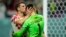 Borna Barisic, left, congratulates his teammate and goalkeeper Dominik Livakovic after Croatia defeated Japan on penalty kicks during the World Cup round of 16 soccer match at the Al Janoub Stadium in Al Wakrah, Qatar, Dec. 5, 2022. 