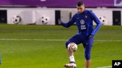 France's Kylian Mbappe kicks the ball during the training session at the Jassim Bin Hamad stadium in Doha, Qatar, Dec. 16, 2022. France will face Argentina in the World Cup final soccer match on Dec. 18. 