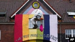 A climate activist hangs from a rope in the village of Luetzerath near Erkelenz, Germany, January 11, 2023.