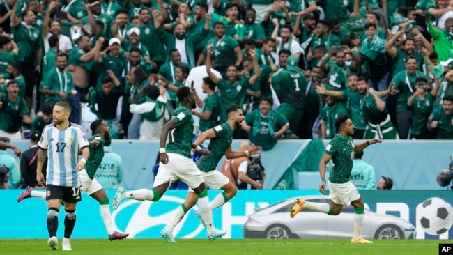 Saudi Arabia's Salem Al-Dawsari, right, celebrates after scoring his side's second goal during the World Cup group C soccer match between Argentina and Saudi Arabia at the Lusail Stadium in Lusail, Qatar, Tuesday, Nov. 22, 2022. (AP Photo/Natacha Pisarenko)