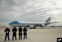 FILE - Military personnel watch as Air Force One, with then-President Donald Trump, aboard prepares to depart at Andrews Air Force Base in the US. state of Maryland, Feb. 17, 2017.