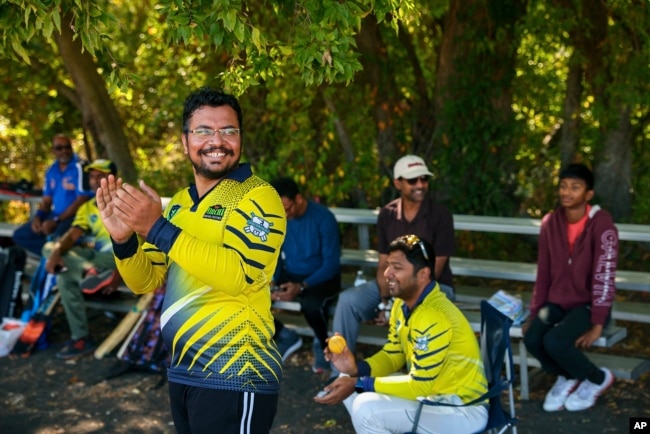 Pavan Kumar Machiraju, left, reacts to a play from the sideline during a cricket match between the Dallas Cricket Connections and the Kingswood Cricket Club on a field adjacent to Roach Middle School in Frisco, Texas, Saturday, Oct. 22, 2022. The teams play in the City of Frisco Cricket league. (AP Photo/Andy Jacobsohn)