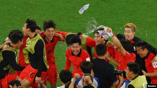 South Korea's Son Heung-min, center, and teammates celebrate after defeating Portugal and qualifying for the knockout stage of the World Cup on Dec. 2, 2022.