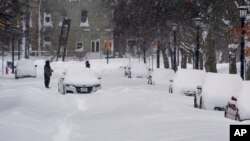 An abandoned car rests on a street in the Elmwood Village neighborhood of Buffalo, N.Y. Monday, Dec. 26, 2022, after a massive snow storm blanketed the city. Along with drifts and travel bans, many streets were impassible due to abandoned vehicles.