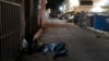 FILE - Two addicts sleep in an alley in Los Angeles, Sept. 21, 2022. 