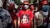 A protester wears a T-shirt depicting detained Myanmar civilian leader Aung San Suu Kyi during a demonstration outside the Embassy of Myanmar in Bangkok on Dec. 19, 2022.