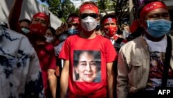 A protester wears a T-shirt depicting detained Myanmar civilian leader Aung San Suu Kyi during a demonstration outside the Embassy of Myanmar in Bangkok on Dec. 19, 2022.