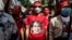 A protester wears a T-shirt depicting detained Myanmar civilian leader Aung San Suu Kyi during a demonstration outside the Embassy of Myanmar in Bangkok on Dec. 19, 2022.