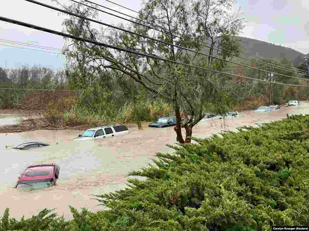 Cars are seen submerged in flood waters in Morro Bay, California, Jan. 9, 2023 in this picture obtained from social media. 