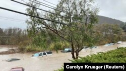 Cars are seen submerged in flood waters in Morro Bay, California, Jan. 9, 2023 in this picture obtained from social media. 