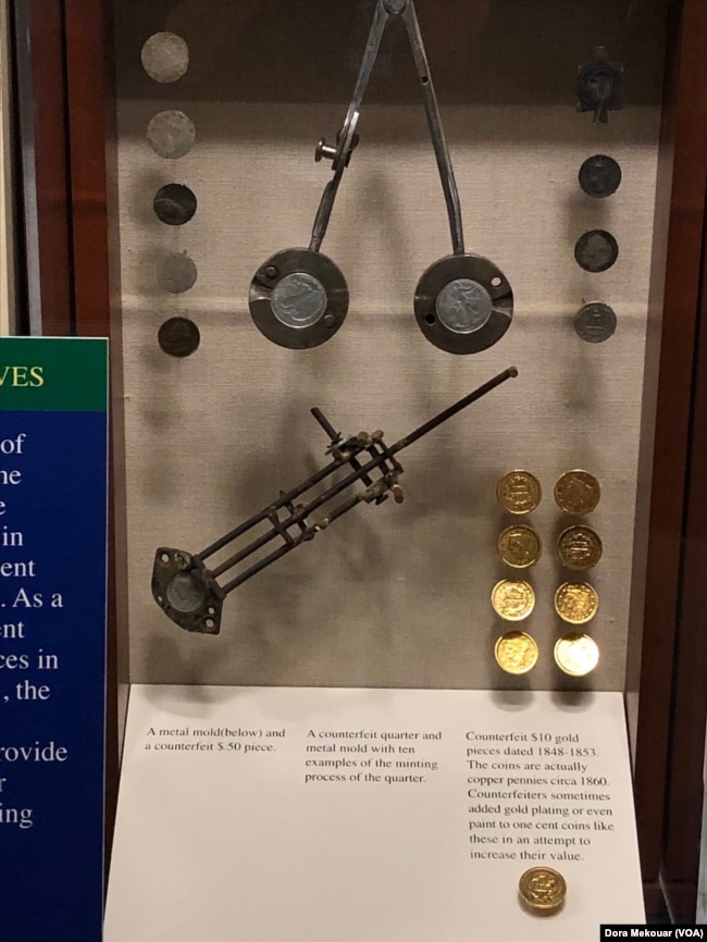 Counterfeit $10 gold coins on display at the U.S. Secret Service Museum are actually copper pennies. (Dora Mekouar/VOA)