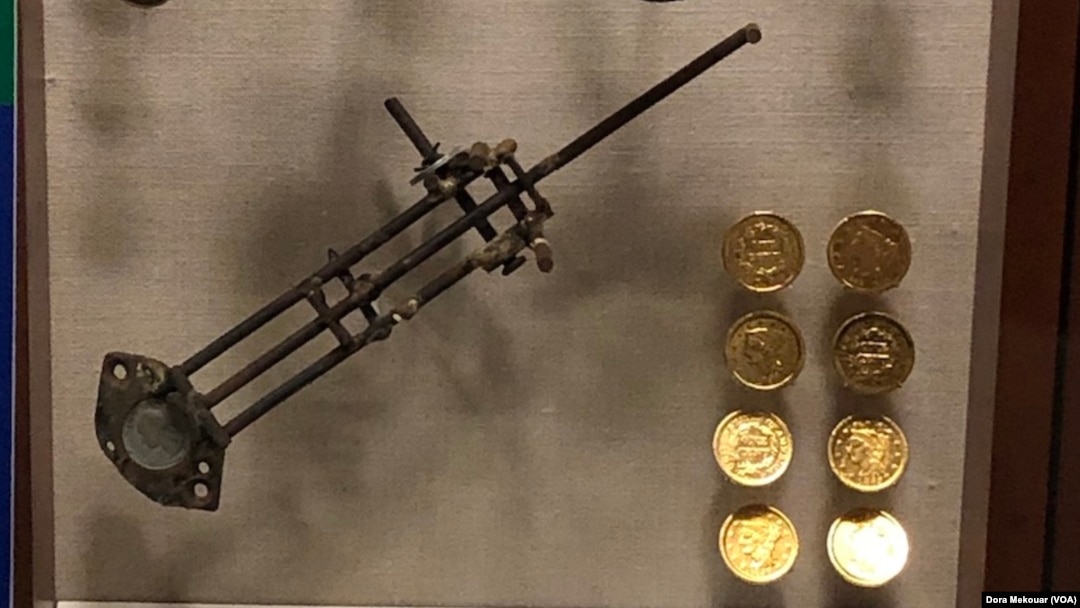 Counterfeit equipment and fake $10 gold coins made out of copper pennies on display at the U.S. Secret Service Museum.