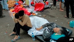 Earthquake survivors are treated outside of a hospital in Cianjur, West Java, Indonesia, Nov. 21, 2022.