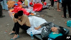 Earthquake survivors are treated outside of a hospital in Cianjur, West Java, Indonesia.&nbsp;A powerful earthquake has toppled buildings on the country&#39;s densely populated main island, killing at least 162 people and injuring hundreds.&nbsp;