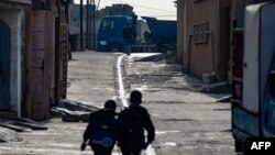 Children walk to school in Iraq's northern city of Mosul on Dec. 11, 2022.