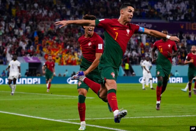 Portugal's Cristiano Ronaldo celebrates after scoring from the penalty spot his side's opening goal against Ghana during a World Cup Group H soccer match at the Stadium 974 in Doha, Qatar, Nov. 24, 2022.