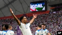 Jude Bellingham celebrates after scoring England's opening goal during the World Cup group B soccer match between England and Iran at the Khalifa International Stadium in Doha, Qatar, Nov. 21, 2022. 