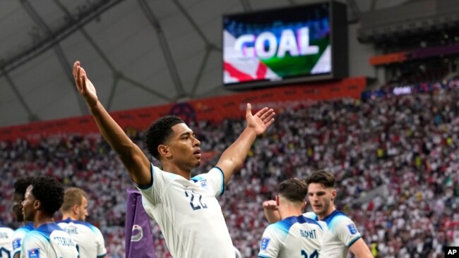 Jude Bellingham celebrates after scoring England's opening goal during the World Cup group B soccer match between England and Iran at the Khalifa International Stadium in Doha, Qatar, Nov. 21, 2022.