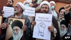 Demonstrators gather with images of Iran's supreme leader Ayatollah Ali Khamenei during a protest against defamatory cartoons depicting him published by French satirical weekly Charlie Hebdo, outside the French embassy in Tehran on Jan. 8, 2023.