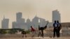 Laborers Play Sandlot Cricket Near World Cup Soccer Stadiums