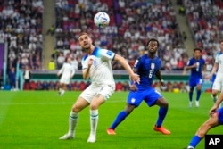 England's Jordan Henderson fights for the ball against Yunus Musah of the United States during the World Cup Group B soccer match between England and the United States, at the Al Bayt Stadium in Al Khor , Qatar, Nov. 25, 2022.