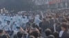 This image grab taken from AFP video footage and posted on Nov. 23, 2022 shows workers at Foxconn's iPhone factory in Zhengzhou in central China clashing with riot police as well as people wearing hazmat suits.