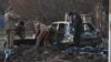 Investigators work near the bodies of local residents killed by shrapnel during Russia's missile attack in Zaporizhzhia, Ukraine, Dec. 5, 2022.