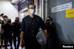 FILE - Former Stand News editor-in-chief Chung Pui-kuen leaves the court after release on bail over his charge of conspiring to publish Seditious Publications in Hong Kong, Dec. 13, 2022.