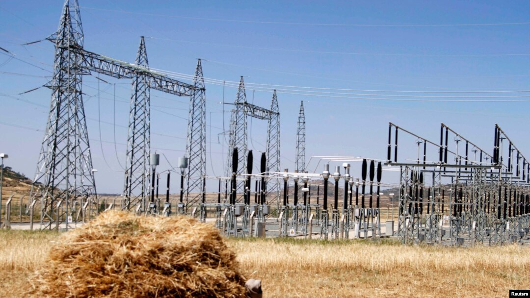 FILE - A farmer naps in a barley field next to an electricity power plant near a village in Mekelle, Tigray, Oct. 25, 2013. Ethiopia's electric company says it has reconnected the capital city to the national grid. 