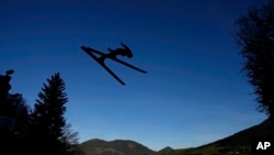 Michael Hayboeck of Austria soars through the air at the fourth stage of 71th Four Hills ski jumping tournament in Bischofshofen, Austria, Jan. 6, 2023.