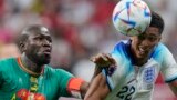 England's Jude Bellingham, right, struggles for the ball with Senegal's Kalidou Koulibaly during the World Cup round of 16 soccer match between England and Senegal, at the Al Bayt Stadium in Al Khor, Qatar, Dec. 4, 2022.