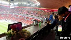 Flowers are laid in memory of journalist Grant Wahl at his assigned press row seat at Al Bayt Stadium in Al Khor, Qatar, Dec. 10, 2022.