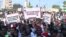 FILE: Senegalese journalists hold banners and shout slogans during the march for the release of their colleague Pope Ale Niang in Dakar on November 18, 2022, arrested for being critical of the government. 