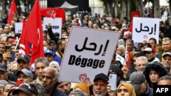 Tunisian demonstrators take part in a rally against President Kais Saied, called for by the opposition "National Salvation Front" coalition, in the capital Tunis, on December 10, 2022. 