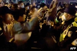 Des manifestants crient des slogans lors d'une confrontation avec la police, à Shanghai, en Chine, le 27 novembre 2022. (capture d'écran)