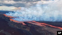 In this aerial photo released by the U.S. Geological Survey, the Mauna Loa volcano is seen erupting from vents on the Northeast Rift Zone on the Big Island of Hawaii, Nov. 28, 2022. 
