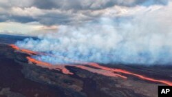 In this aerial photo released by the U.S. Geological Survey, the Mauna Loa volcano is seen erupting from vents on the Northeast Rift Zone on the Big Island of Hawaii, Nov. 28, 2022. 