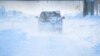 Vehicles drive through blowing snow following a winter storm that hit the Buffalo region on Main St. in Amherst, New York, Dec. 25, 2022. 